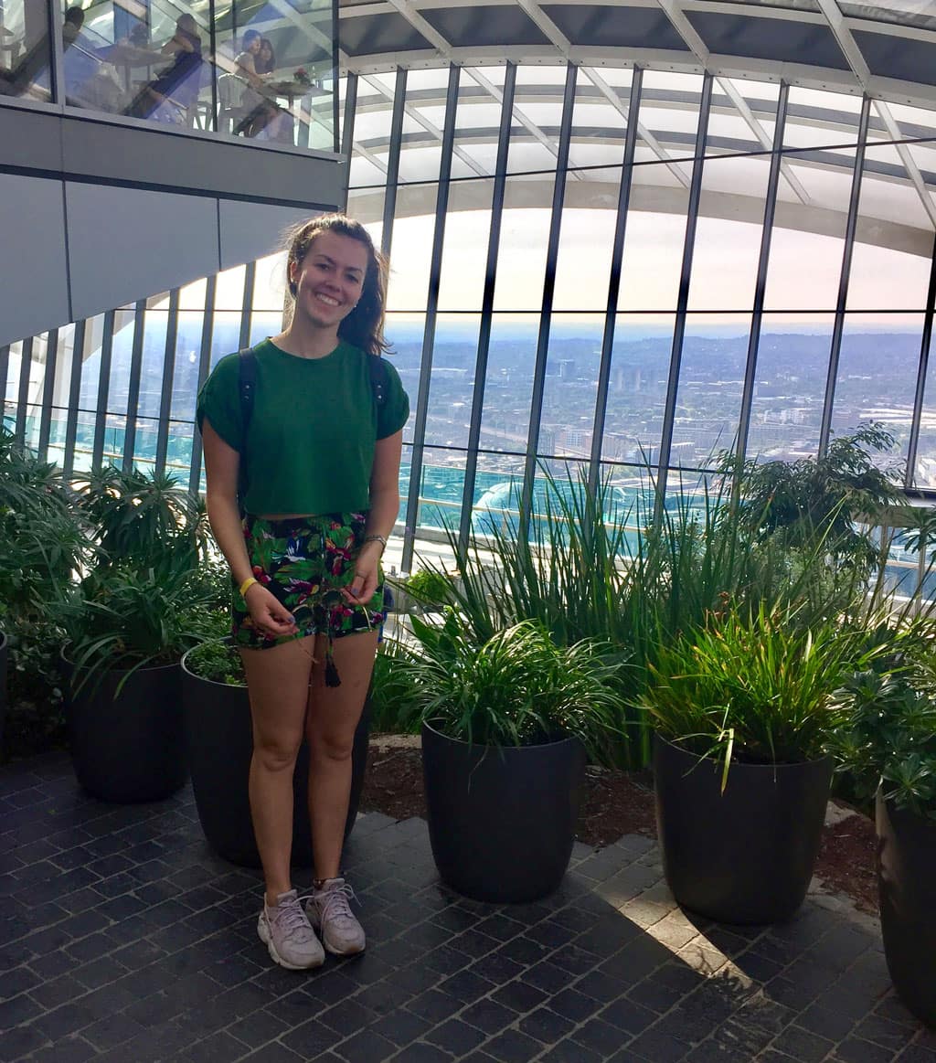 London for Digital Nomads: Katie smiling from the Sky Garden viewpoint looking over London's skyline
