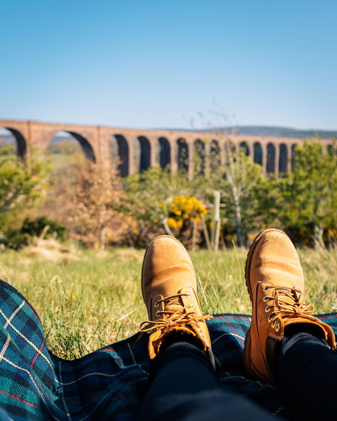 Culloden Viaduct in the background of Scottish Tartan and Walking Boots