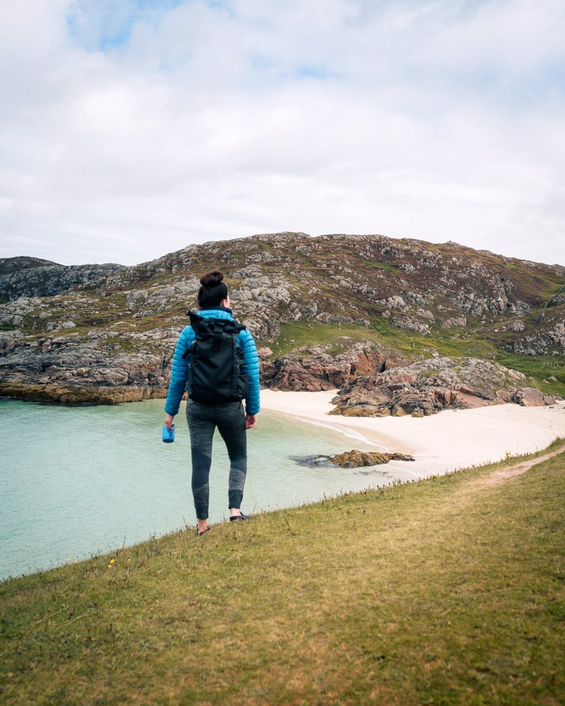 NC500 Road Trip: Katie standing at Achmelvich Beach