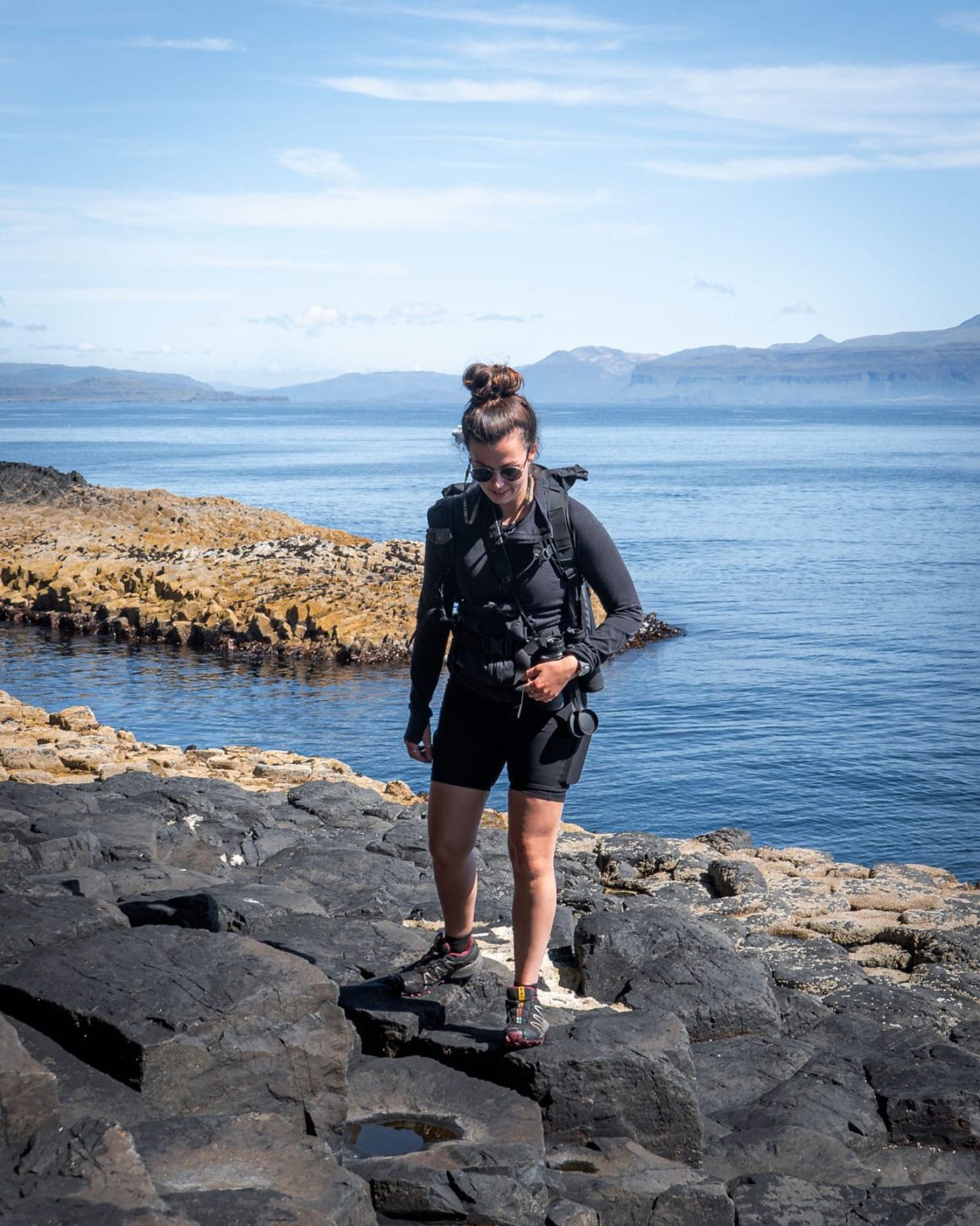 Katie standing on the hexagonal pillars of the Isle of Staffa near Fingal's Cave